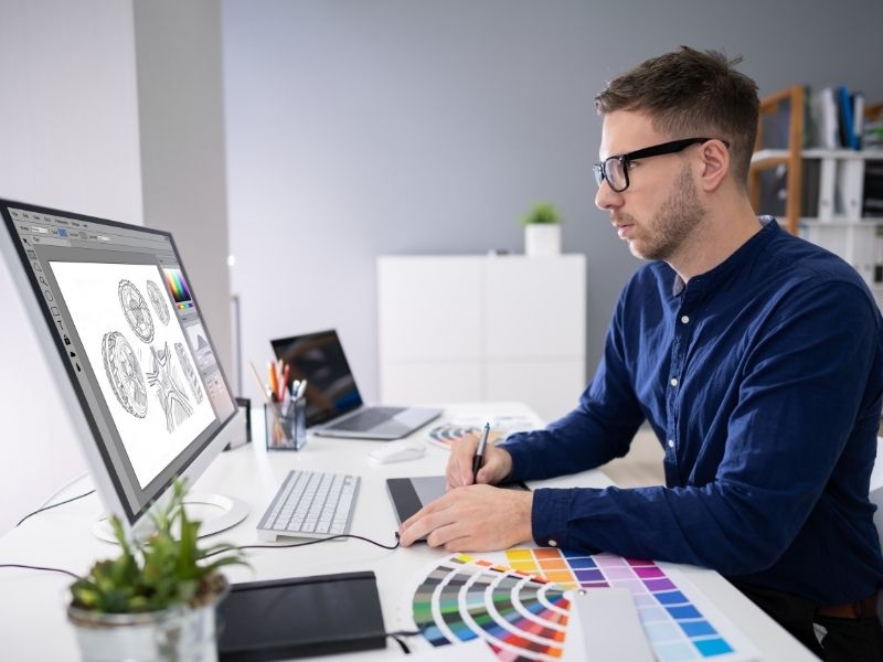 freelance designer working on laptop managing business finances